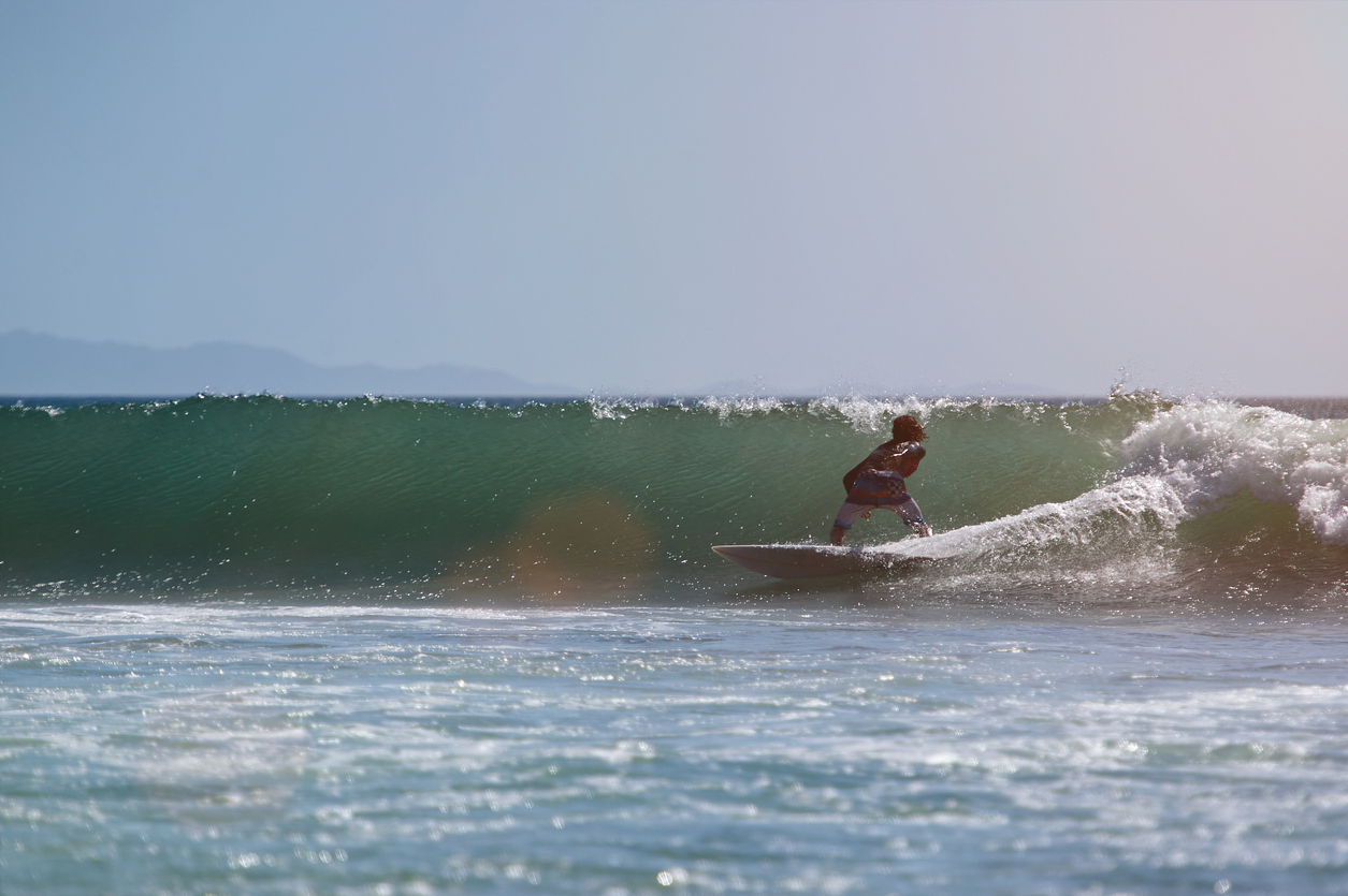 Surfer in Pacific waves Surfer in Pacific waves