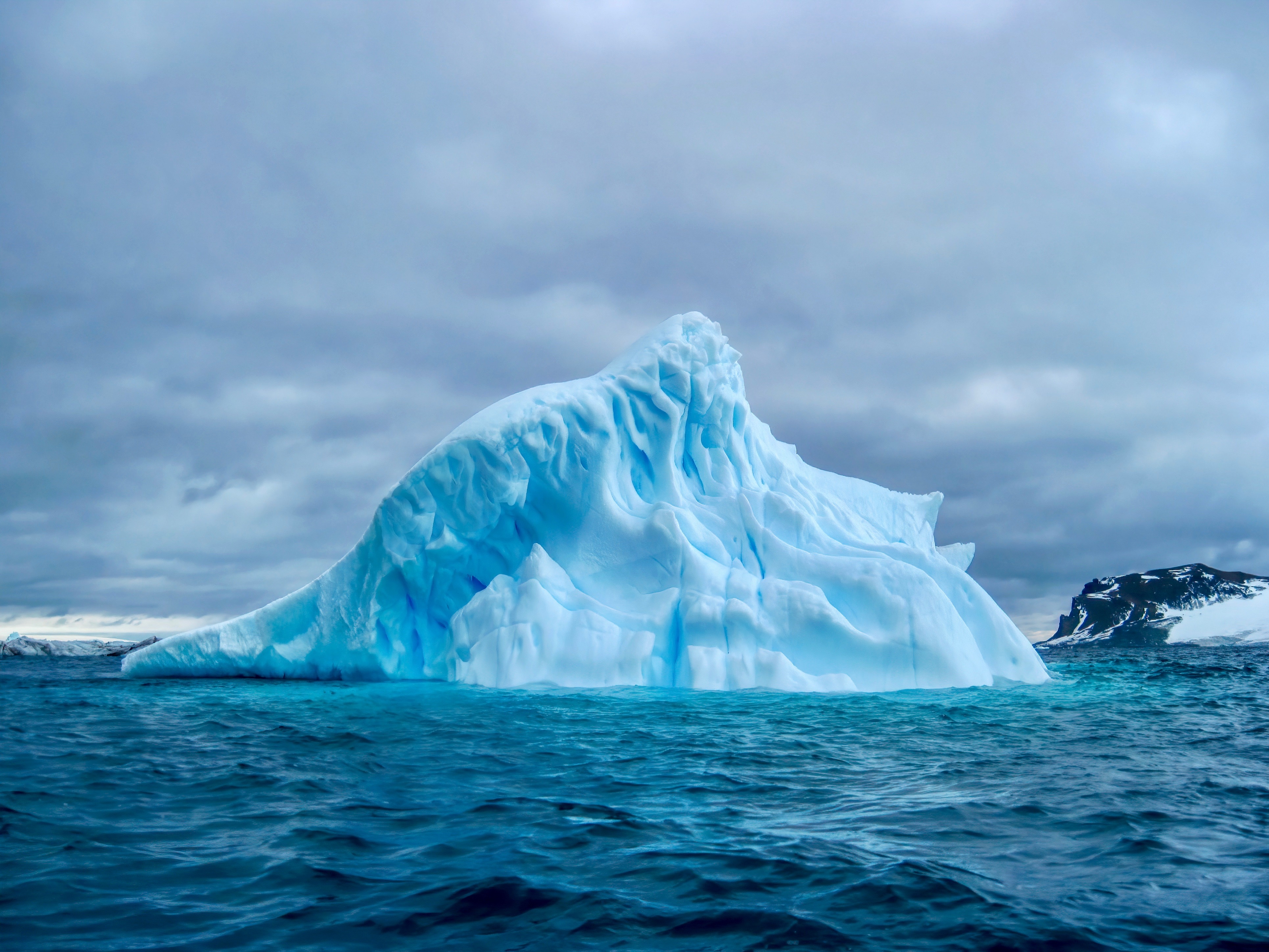 A Blue Iceberg Drifting In The South Atlantic Ocean Off The Coast Of South Georgia Island. A Blue Iceberg Drifting In The South Atlantic Ocean Off The Coast Of South Georgia Island.