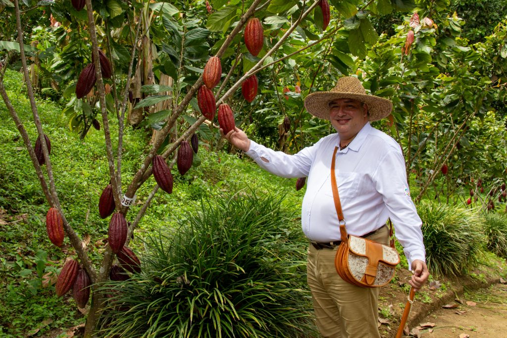 Jose checks on the cacao plant